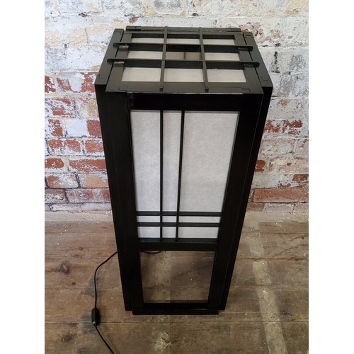 185 - A traditional Japanese black lacquer floor lamp with cream fabric insets.Height 76cm x width 31cm x ... 