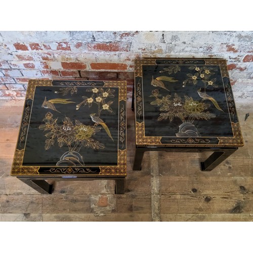 187 - A pair of 20th century black lacquered hand painted Japanese occasional tables, decorated with flowe... 