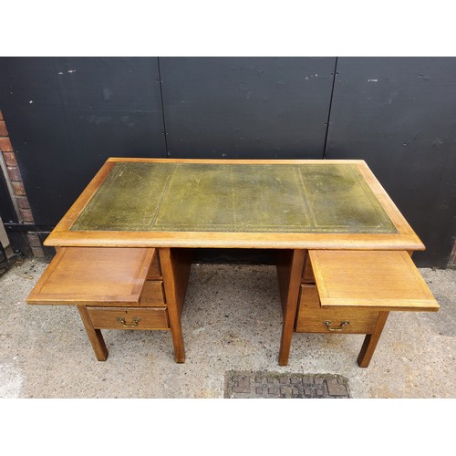 206 - A 1940's oak knee-hole desk with green tooled leather inlaid top, five drawers.H77 x W137 x D76cm... 