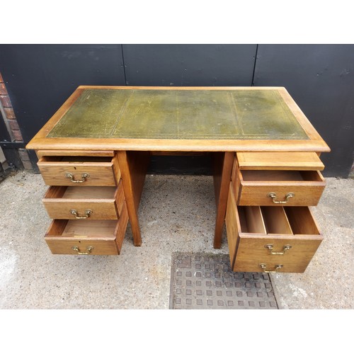 206 - A 1940's oak knee-hole desk with green tooled leather inlaid top, five drawers.H77 x W137 x D76cm... 