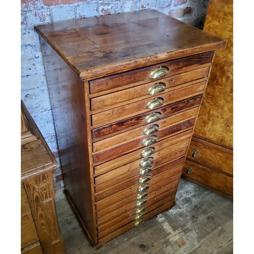 207 - A late 19th century farmhouse pine bank of sixteen collectors drawers / printers drawers with brass ... 