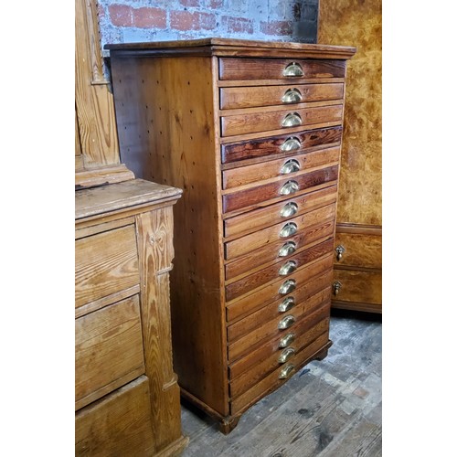 207 - A late 19th century farmhouse pine bank of sixteen collectors drawers / printers drawers with brass ... 