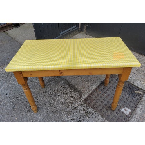 215 - A farmhouse pine side table with two small drawers to frieze, covered in fitted yellow plastic 