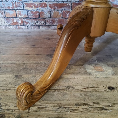 240 - An early 20th century farmhouse pine dining / tavern table, bold turned support with carved shaped l... 