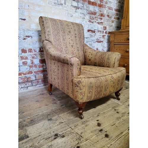 244 - A late Victorian armchair re- upholstered in chintz striped fabric, raised on mahogany cabriole legs... 