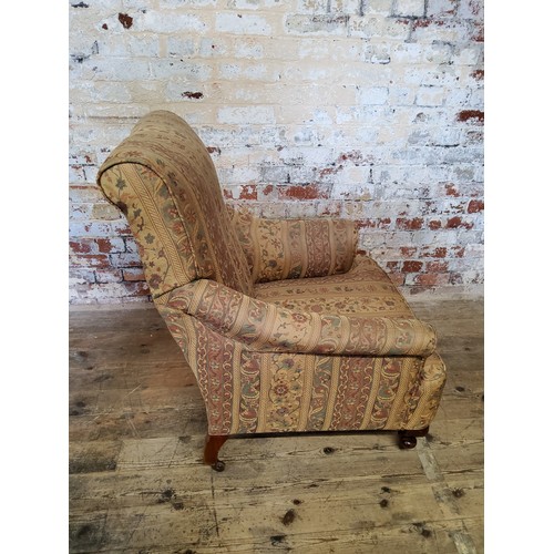 244 - A late Victorian armchair re- upholstered in chintz striped fabric, raised on mahogany cabriole legs... 