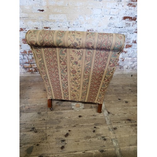 244 - A late Victorian armchair re- upholstered in chintz striped fabric, raised on mahogany cabriole legs... 