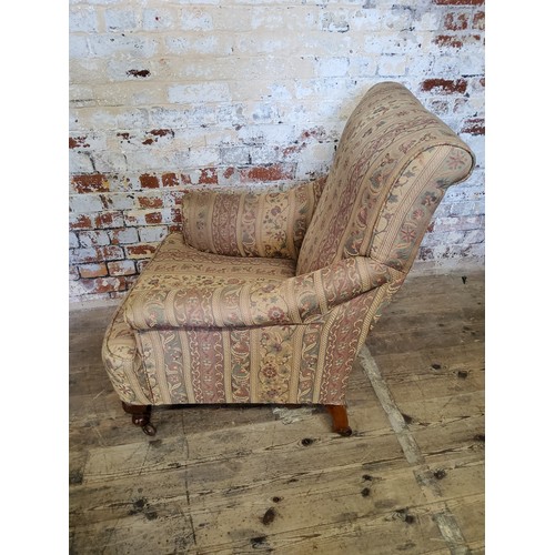 244 - A late Victorian armchair re- upholstered in chintz striped fabric, raised on mahogany cabriole legs... 