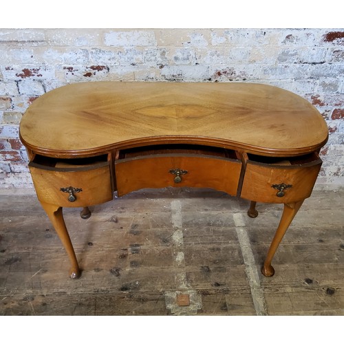 245 - A small kidney shaped dressing table with one long flanked by two short drawersheight 74.5cm x width... 