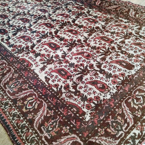 252 - A large early 20th century hand knotted Middle Eastern / Caucasian rectangular carpet, bold paisley ... 