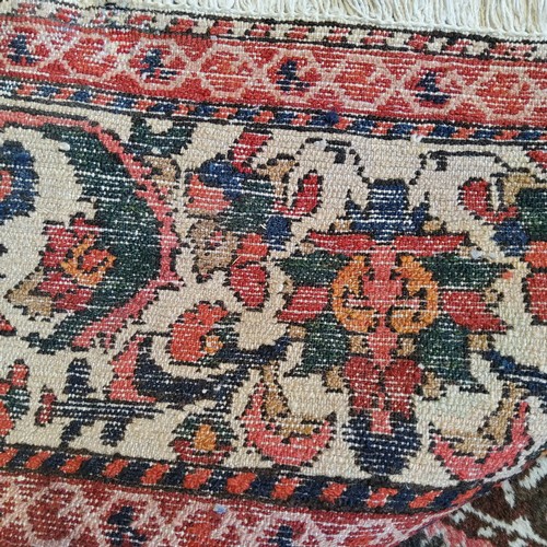 253 - A very large hand knotted Persian Isfahan carpet on a bold red, blue and ivory ground, central flowe... 