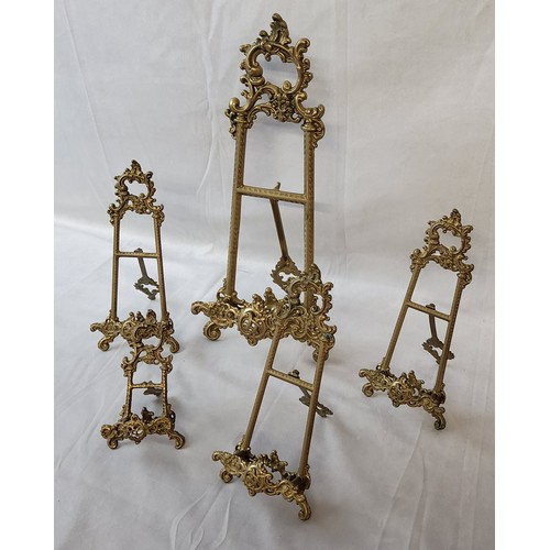 18 - Five decorative Roccoco type brass table easels, various sizes, the largest measures 40cm high