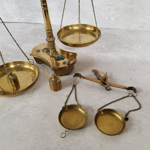 10 - A late Victorian brass double beam weighing scales base holding 8 weights, (AF)39cm heigh x 30cm wid... 