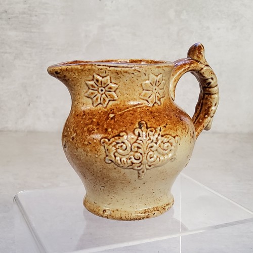 33 - A Derbyshire possibly Brampton saltglazed cream jug decorated in relief with sprigs
