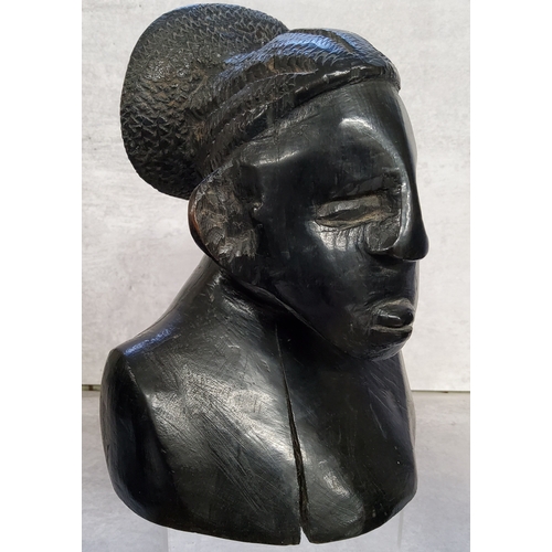 42 - Tribal Art - a carved 19th century African ebony bust of an elder; other carved tribal busts.