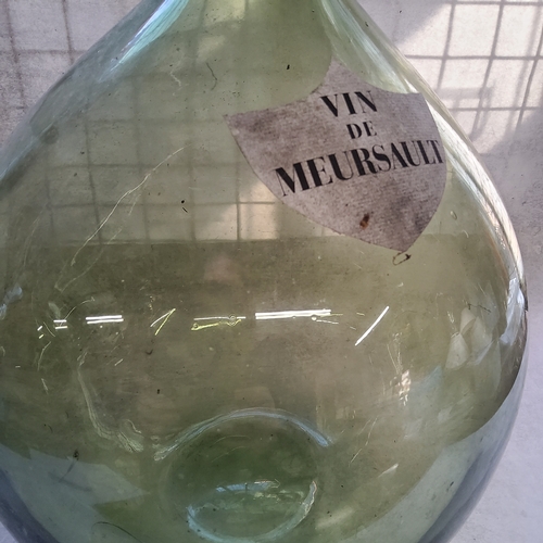 56 - A substantial French carboy / demijohn with a shield shaped label titled 
