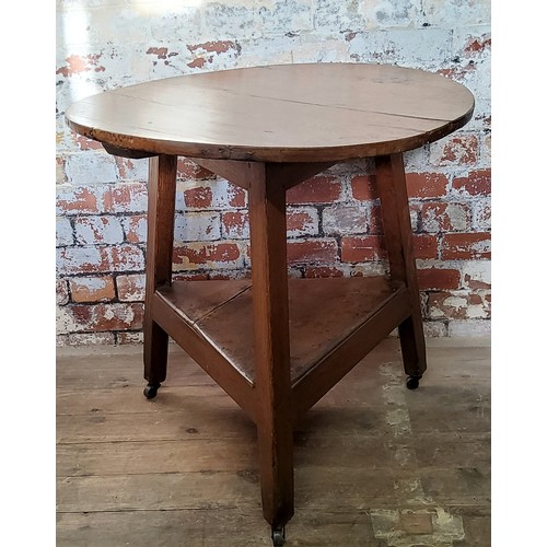 102 - A period English oak cricket table, planked oak and wooden dowel construction, raised on castors, ci... 