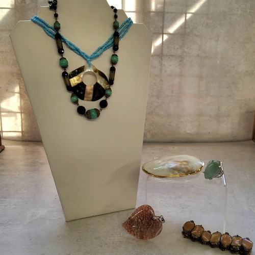 245 - A vintage jewellery box containing various necklaces including a carved alabaster necklace with an a... 