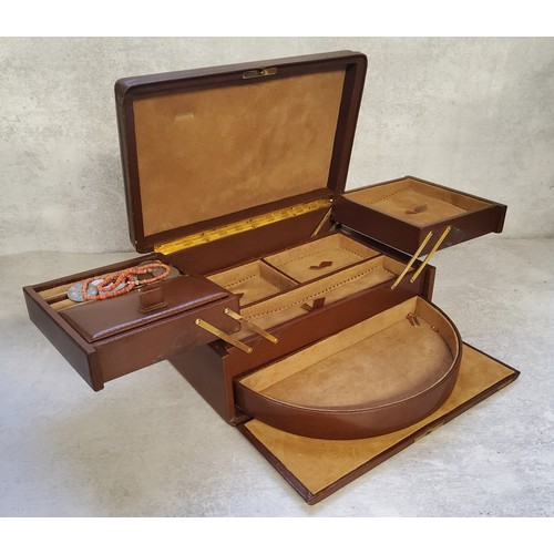 239 - A Morrocan brown leather travel jewellery case, suede lined, fitted interior