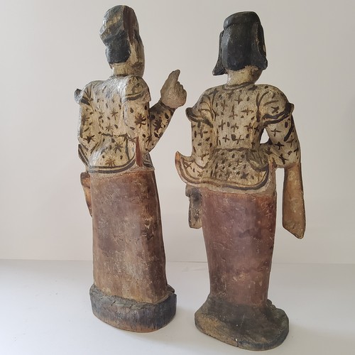 21 - A near pair of Oriental polychrome painted carved wood figures of lady's of title, standing 36cm hig... 