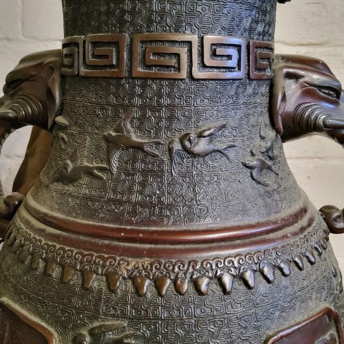 34 - An imposing Japanese 19th century Meiji period bronze vase with twin elephant mask handles, the body... 