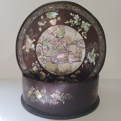 36 - A 19th century Chinese cylindrical box, profusely inlaid with mother of pearl objects of desire, tem... 