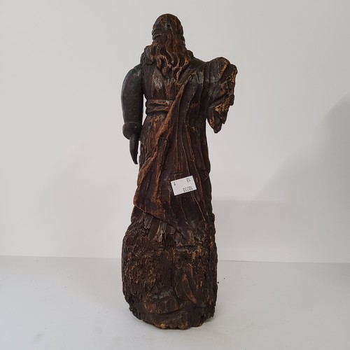 77 - An early 17th century Continental carved Saint figure raised on three cherubs to base. 40cm high