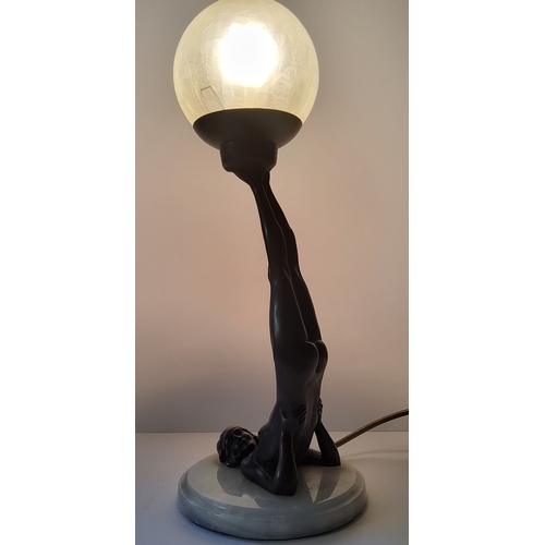 103 - An Art Deco type bronzed table lamp, with gymnastic pose column, frosted globe shade.