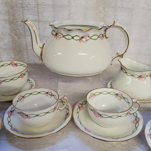 151 - A 1920's Royal Crown Derby part tea service for four, handpainted  with a green ribbon & pi... 