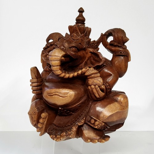 96 - A 20th century carved wood sculpture of the Hindu god Ganesha, India. 26cm high x 27cm wide