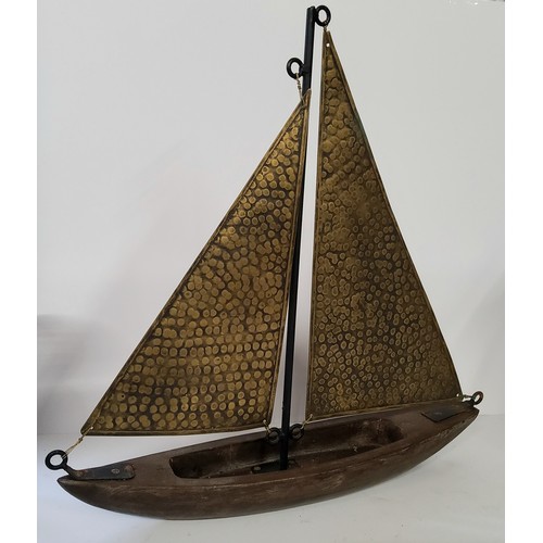 146 - A vintage hand beaten brass and wood yacht model. approx 50cm high.