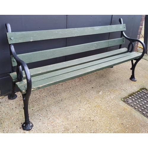 356 - An outdoor garden bench with bold decorative cast iron supports