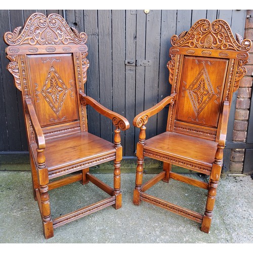 358 - A pair of country house Wainscot type hall chairs, profusely carved head rest with bold lozenge pane... 