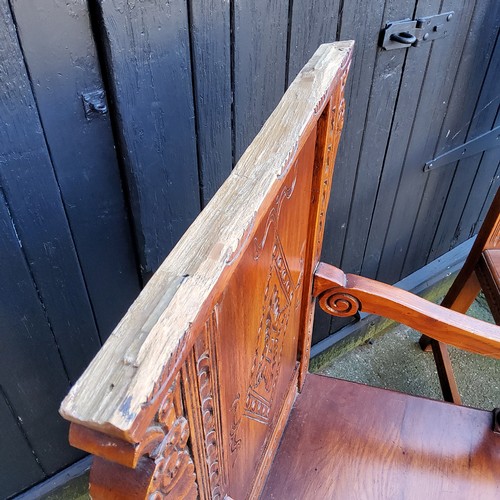 358 - A pair of country house Wainscot type hall chairs, profusely carved head rest with bold lozenge pane... 