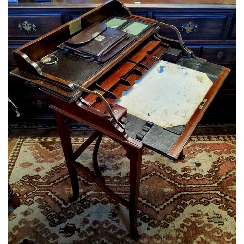 359 - An Edwardian campaign style mahogany writing desk, the hinged rectangular top with sliding mechanism... 