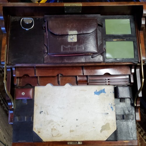 359 - An Edwardian campaign style mahogany writing desk, the hinged rectangular top with sliding mechanism... 