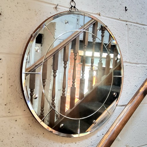 5 - An Art Deco circular looking glass,  with sorcerer's mirror type,  convex inclusions to panelled bor... 