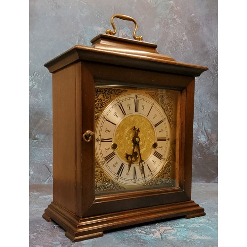 13 - A 20th century mahogany bracket clock, Indian mask foliate scroll spandrels, Roman numerals, three w... 