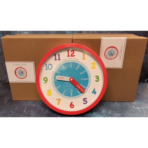 38 - Eight London Clock Company 'Tell the Time' wall hanging clocks, NOS, original packaging