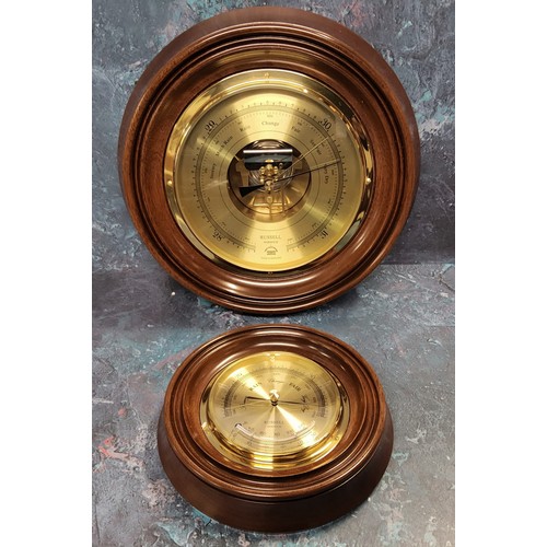 64 - A circular brass barometer, mahogany mount, twin diaphragm, the brass dial marked Russell of Norwich... 