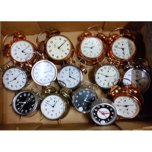 112 - Fourteen Timemaster, Tudor and Peter alarm clocks in a variety of copper, brass and chrome finishes.