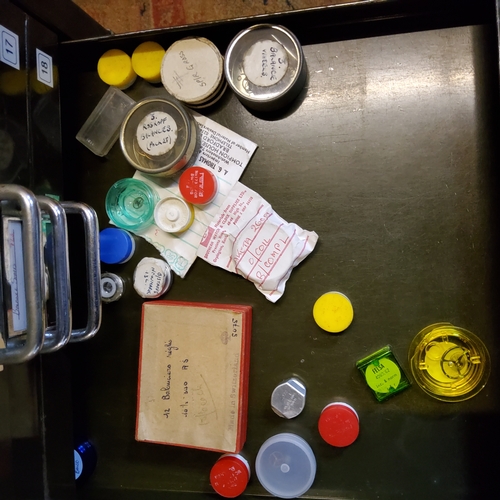 165 - A Watchmaker's metal cabinet, housing an annotated collection of setting lever springs, winding pins... 