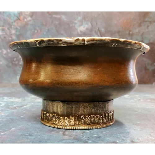 219 - A Tibetan white metal mounted indigenous timber circular libation bowl, raised foot ring, 10cm diam