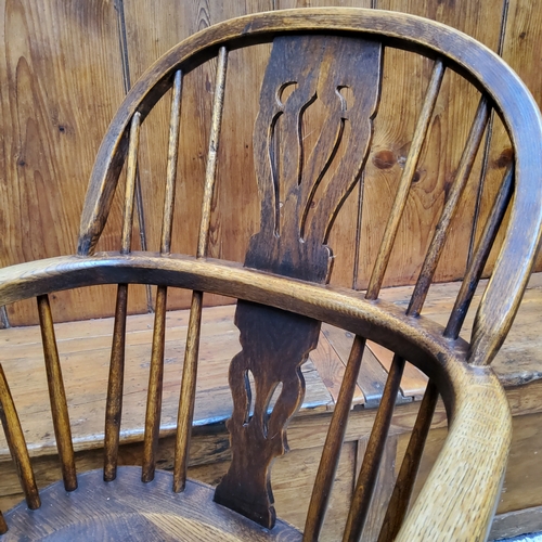 3 - An early 19th century ash and elm Windsor chair, shaped pierced splat with a shaped seat on turned l... 