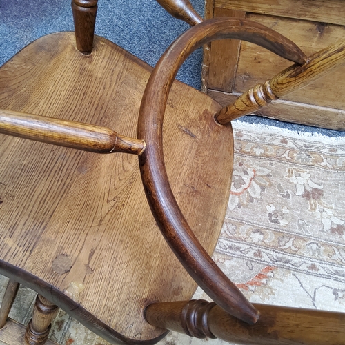 3 - An early 19th century ash and elm Windsor chair, shaped pierced splat with a shaped seat on turned l... 