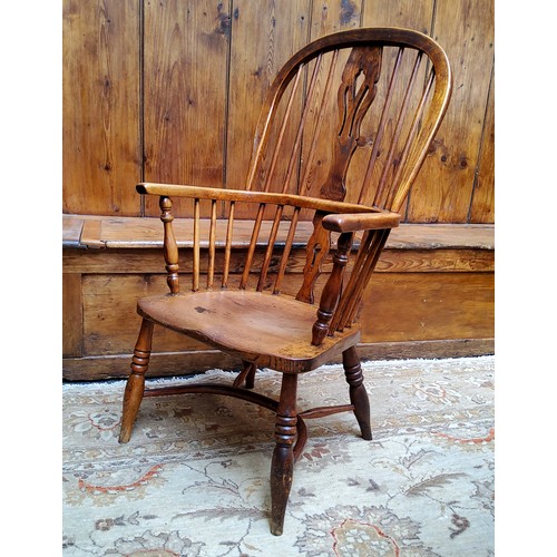 7 - An early 19th century ash and elm Windsor chair, crinoline stretcher, c.1820