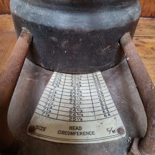 11 - A Victorian fruitwood milliner's hat stretcher, the wrought iron handle dividing the block according... 