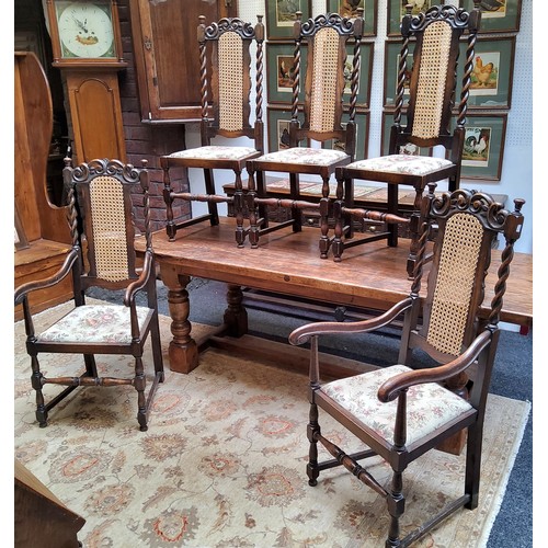 19 - A set of five early 20th century oak dining chairs, including two elbow chairs, bergere backs flanke... 