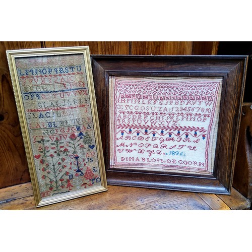 24 - A Victorian needlework sampler, embroidered with alphabet, numbers, acorns and foliage, dated 1876, ... 