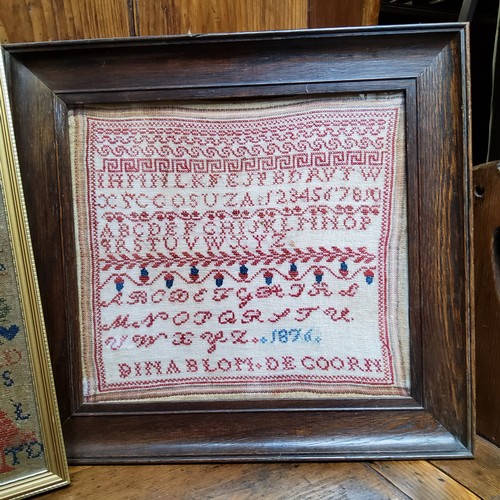 24 - A Victorian needlework sampler, embroidered with alphabet, numbers, acorns and foliage, dated 1876, ... 